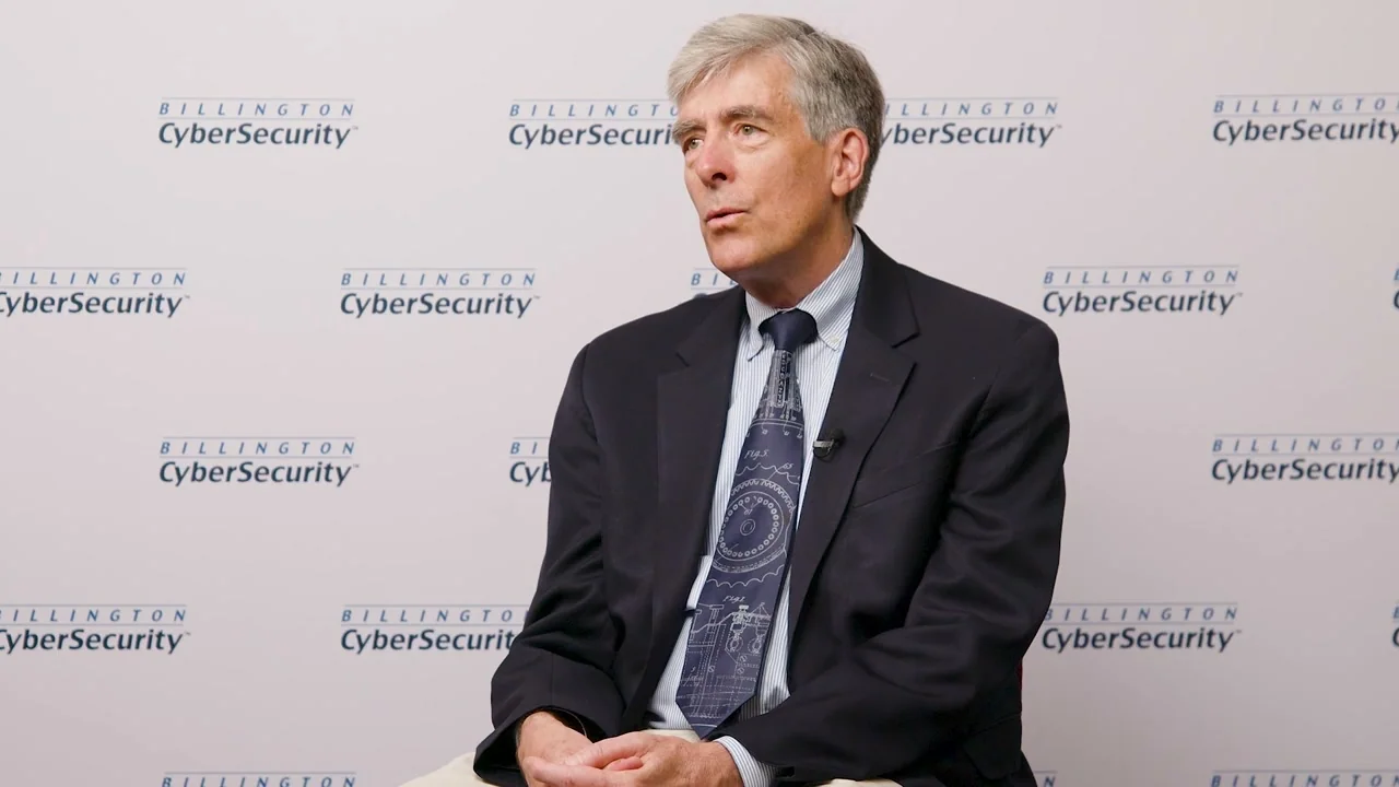 Seated interview with a summit speaker on a branded backdrop
